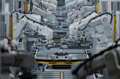 Automated robotic arms assembling components on a production line.